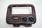 99 00 CHRYSLER TOWN AND COUNTRY CLIMATE CONTROL DASH BEZEL WOOD GRAIN